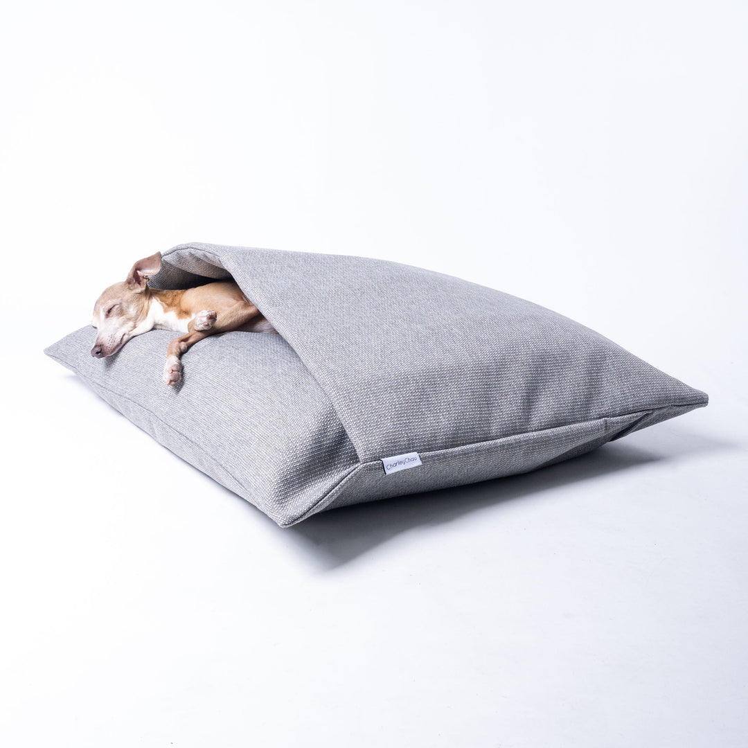 A Dog Snuggle Bed made specifically for dogs that scratch at their beds as part of their nesting ritual. The top of the bed has an insualted duvet cover to keep your dog calm, cosy and content.