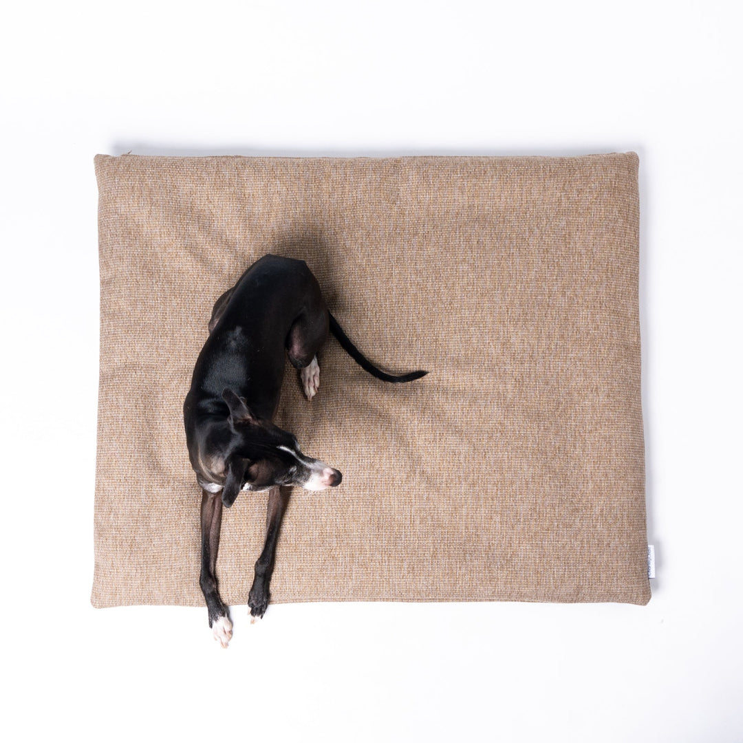 Luxury Dog Travel Pad by designer Charley Chau with a dog lying on top, in Weave II, a textured upholstery fabric in a warm neutral tone called Oak.