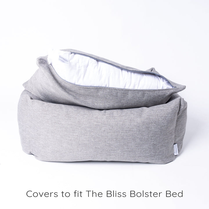 Luxury bolster dog bed by Charley Chau showing the zip of the mattress bed cover open to reveal the internal deep-filled luxury dog bed mattress.