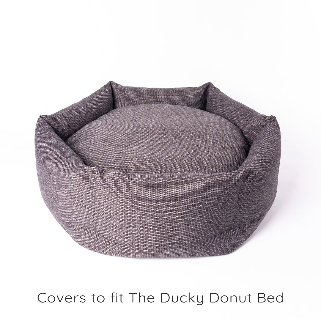 The Ducky Donut Dog Bed by designer Charley Chau. A luxury donut dog bed with ethically sourced duck feather pads in the donut ring.